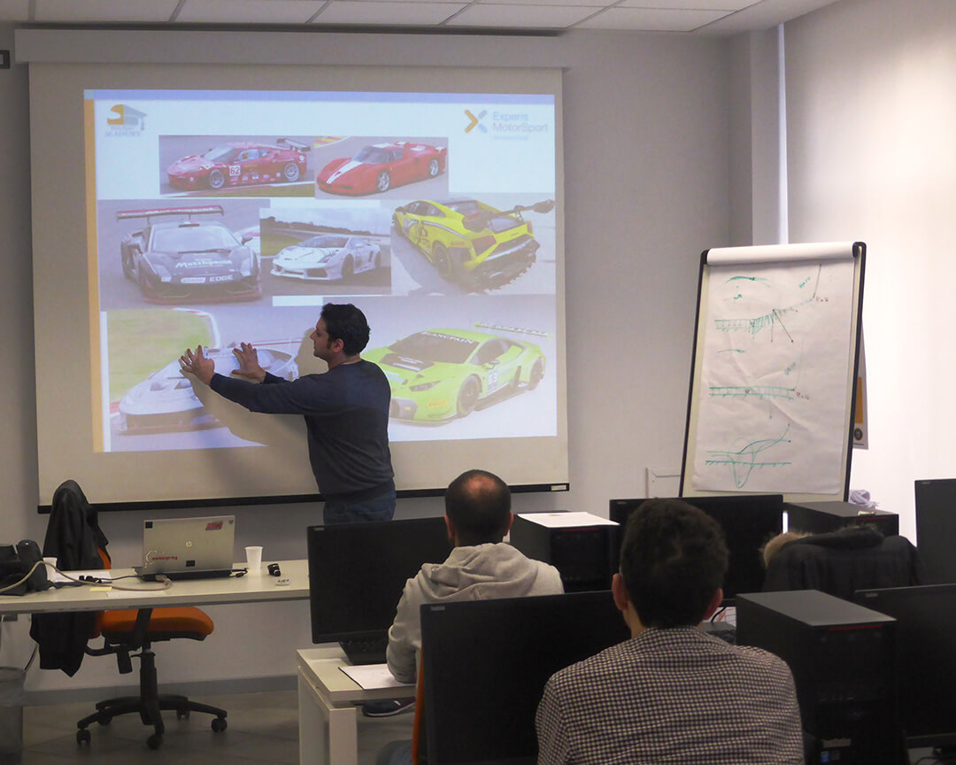 teacher explaining specific course car techniques, view of students from behind