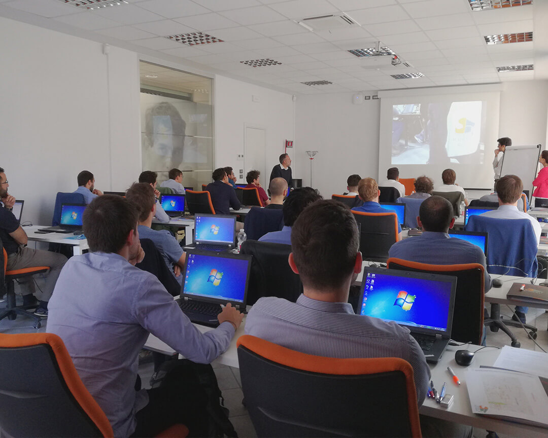 view from behind a classroom of students, you can see the computer screens with the windows logo