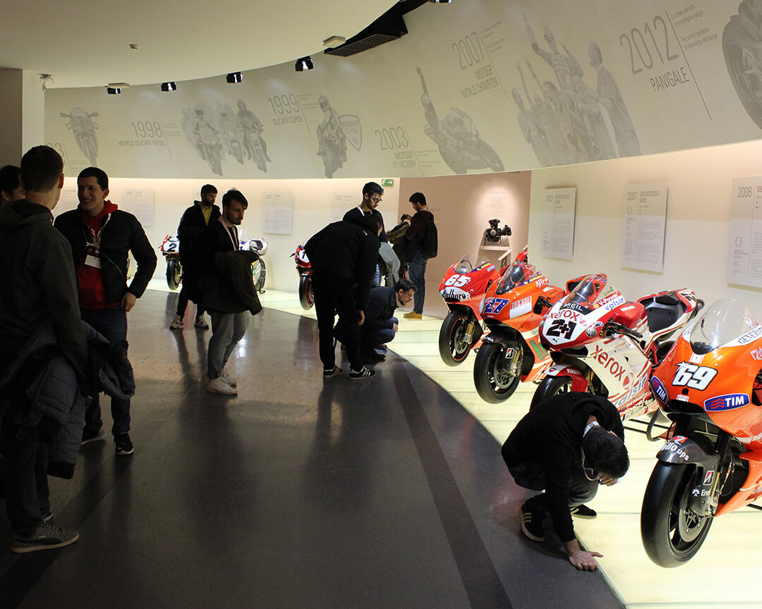 Muner students visiting Ducati Museum among vintage MotoGP bikes