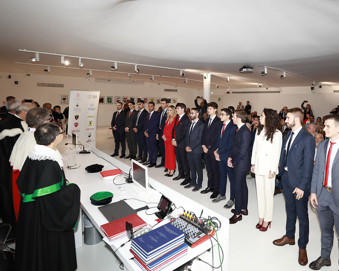 Graduation photos of Muner students lined up in front of professors
