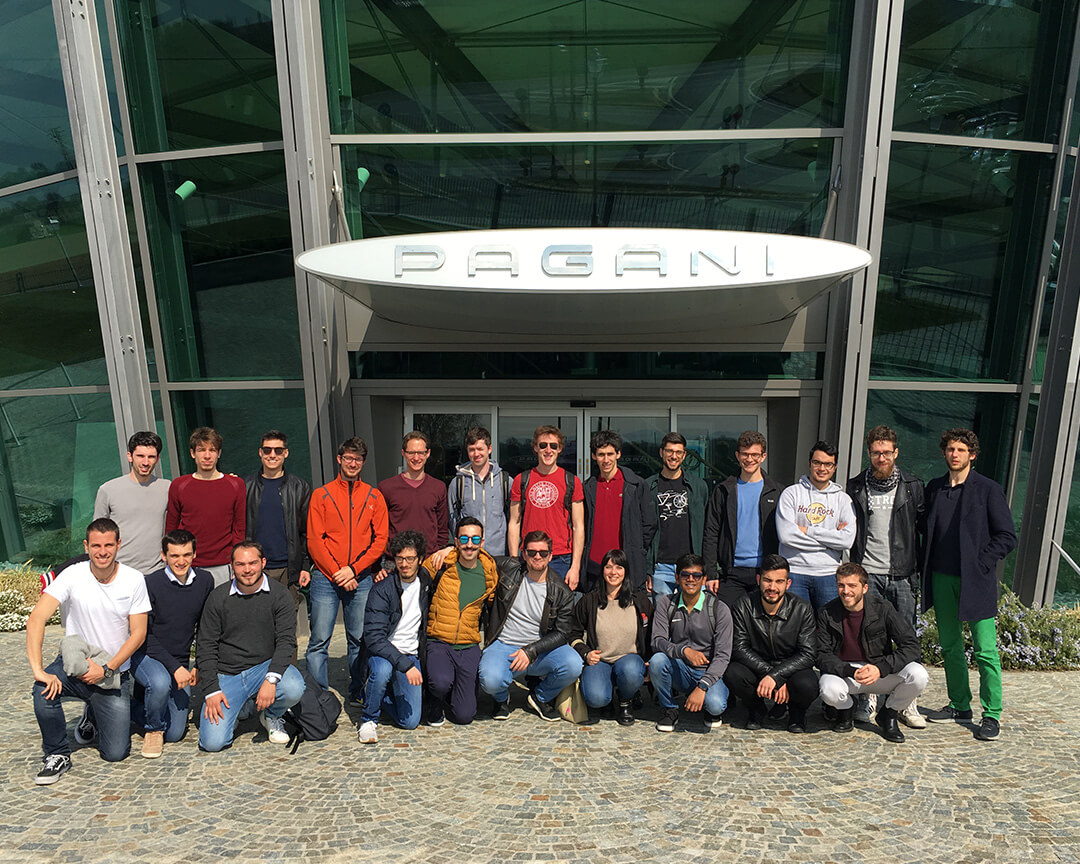 Class photo Muner students visiting the Pagani Museum in front of the sign