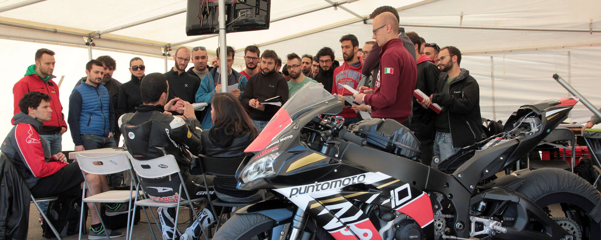 Motorcycle master students in a group with the pilot