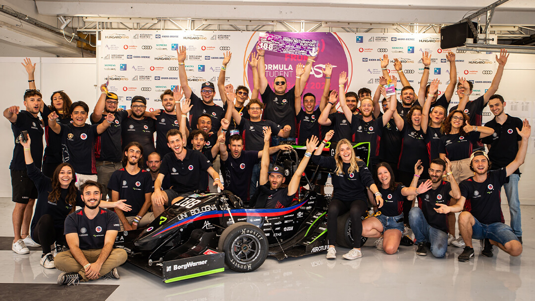 group of motorsport boys rejoicing happily