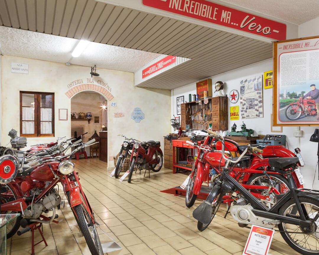 guzzi collection motorcycles on display in an old tavern room with house number and bulk wine plate