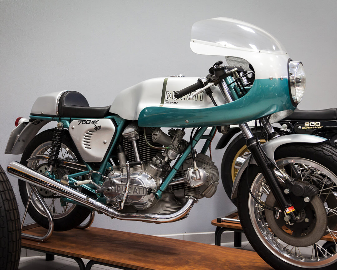 side view of a teal and grey Ducati model 900 super sport motorbike