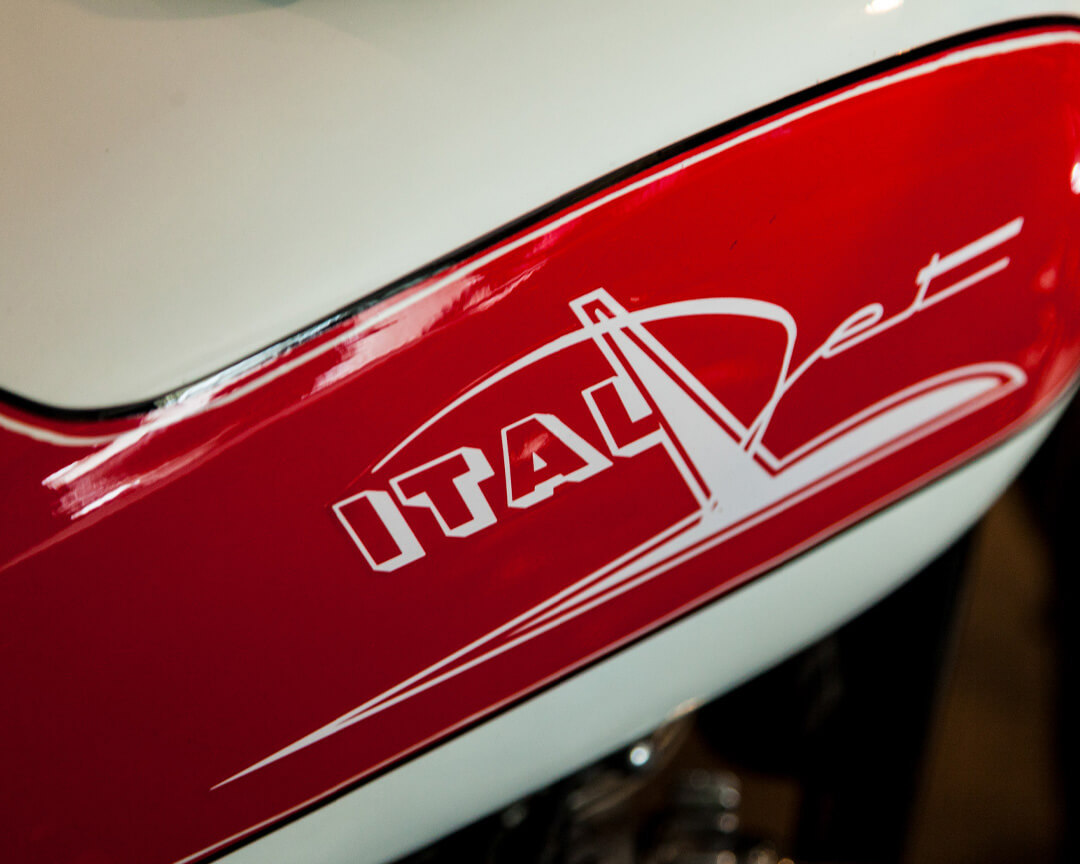 On the fairing of a vintage motorcycle from the pasquale mesto collection, you can see the detail of Italjet's logo in white on red paint
