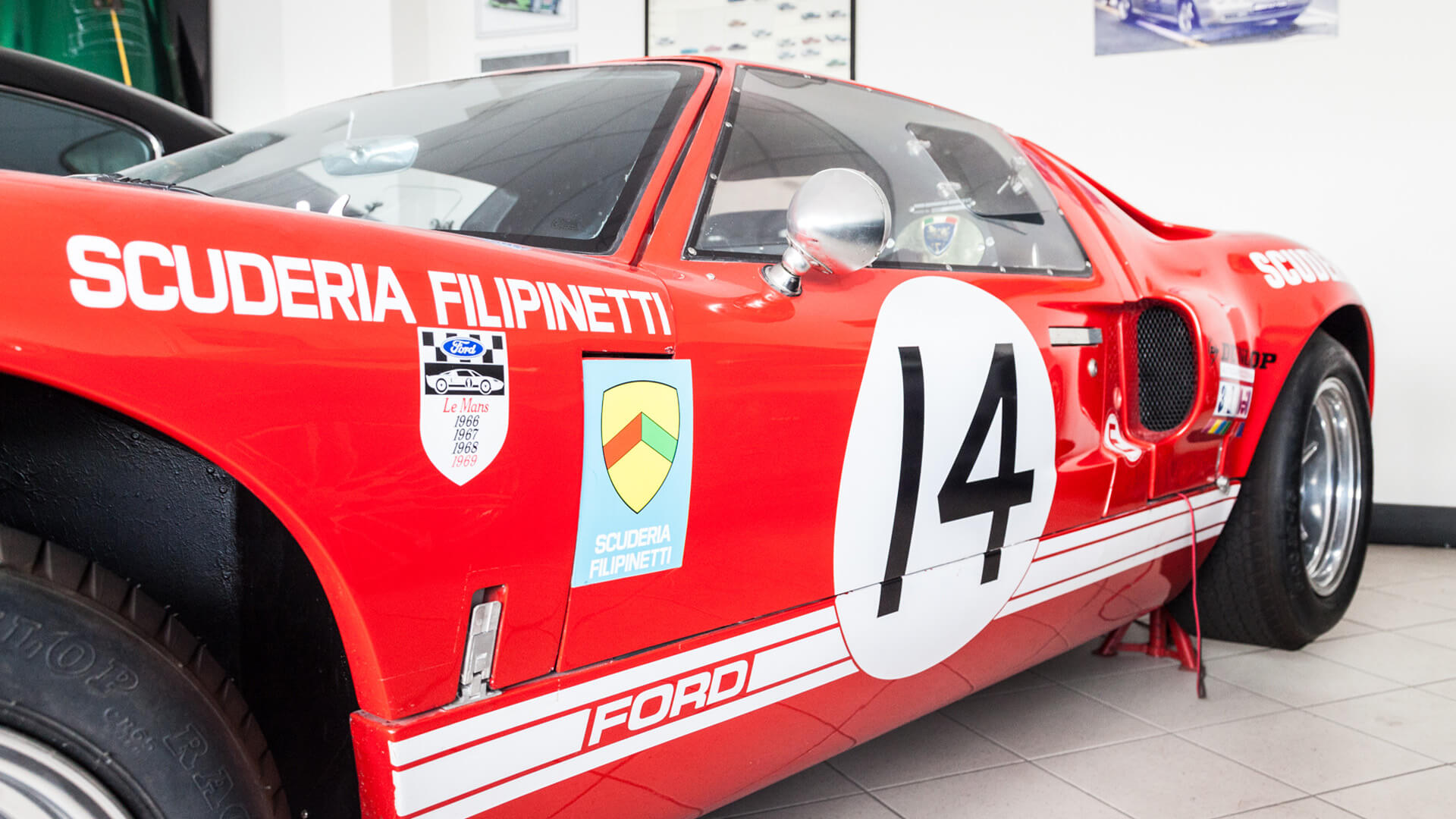 Side of a red Ford GT with the number 14 of the Filipinetti stable, kept in the pollini collection