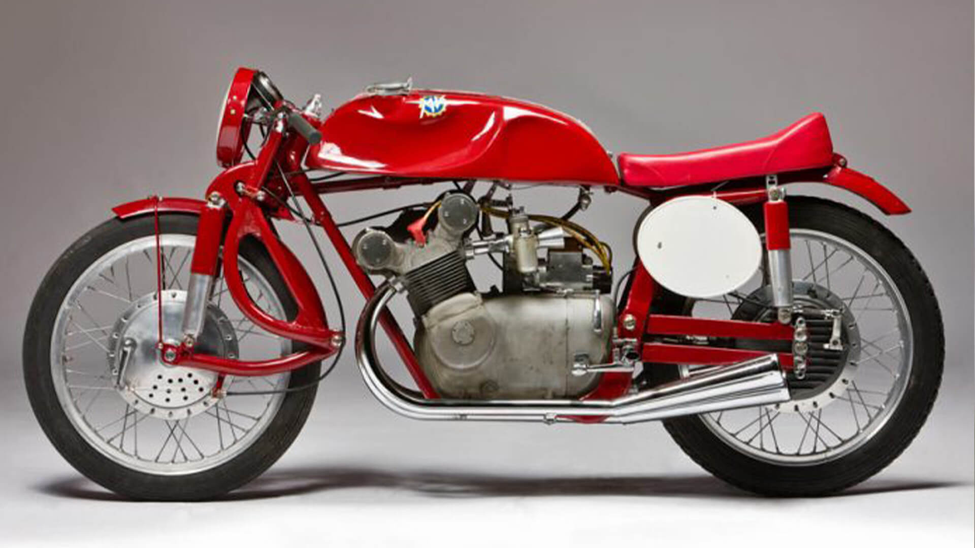 Side view of a red MV agusta motorbike, part of the villa italia collection