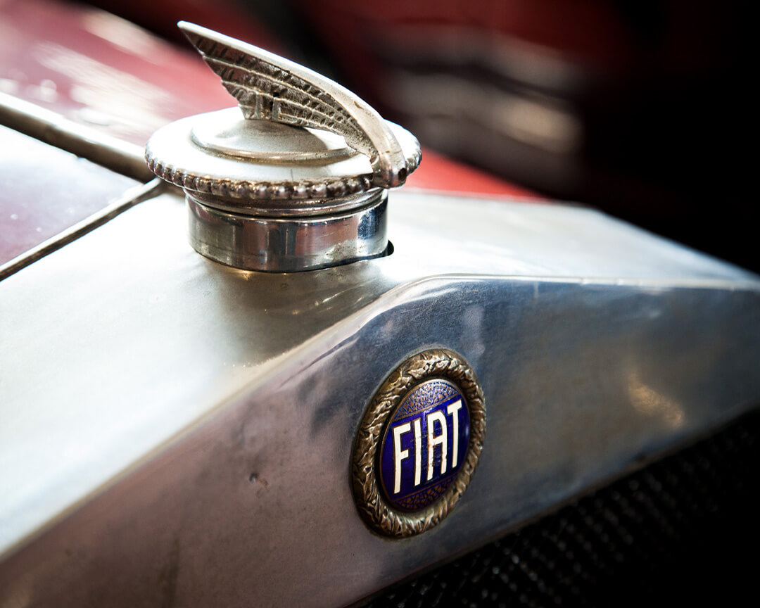 Detail on the fiat logo of a vintage car of the scuderia san martino, also showing the embossed logo