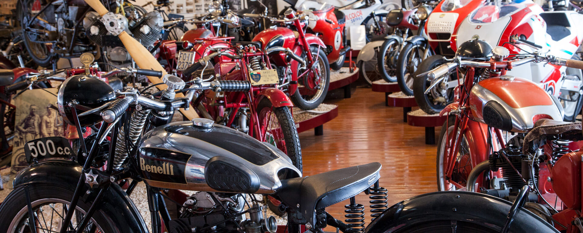 A series of vintage motorbikes in the exhibition hall of the national motorbike museum, in the foreground a black Benelli collector's motorbike.