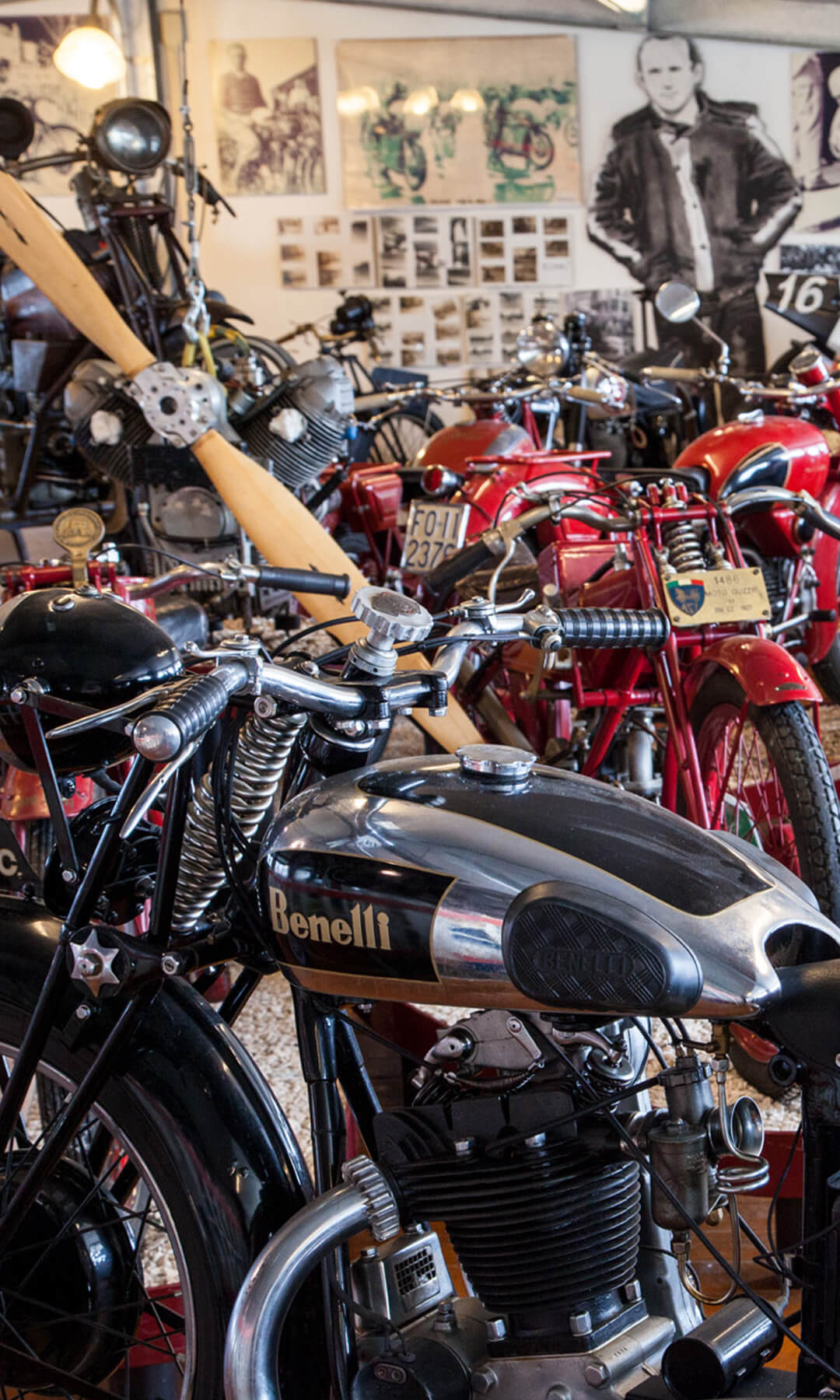 A series of vintage motorbikes in the exhibition hall of the national motorbike museum, in the foreground a black Benelli collector's motorbike.