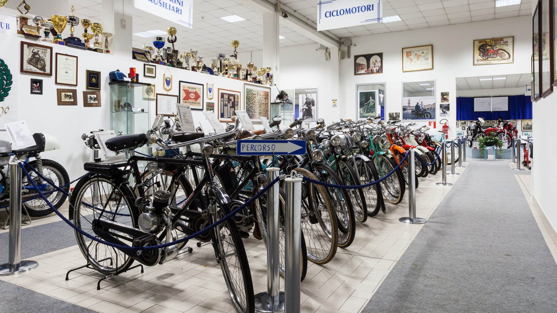 One of the exhibition rooms of the Bariaschi motorbike museum, with the entire moped section, trophies, memorabilia, posters, and historical motorcycling photos inside