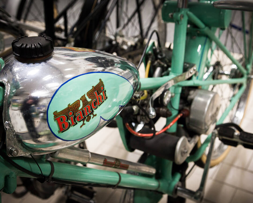 Detail of a Bianchi logo tank of a motorised collector's bike inside the Bariaschi motorbike museum