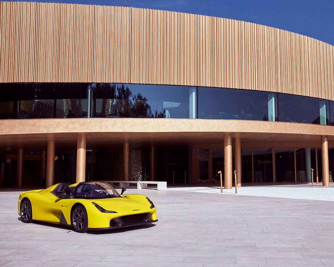 view from outside the Dallara museum with yellow Dallara super car parked at the entrance
