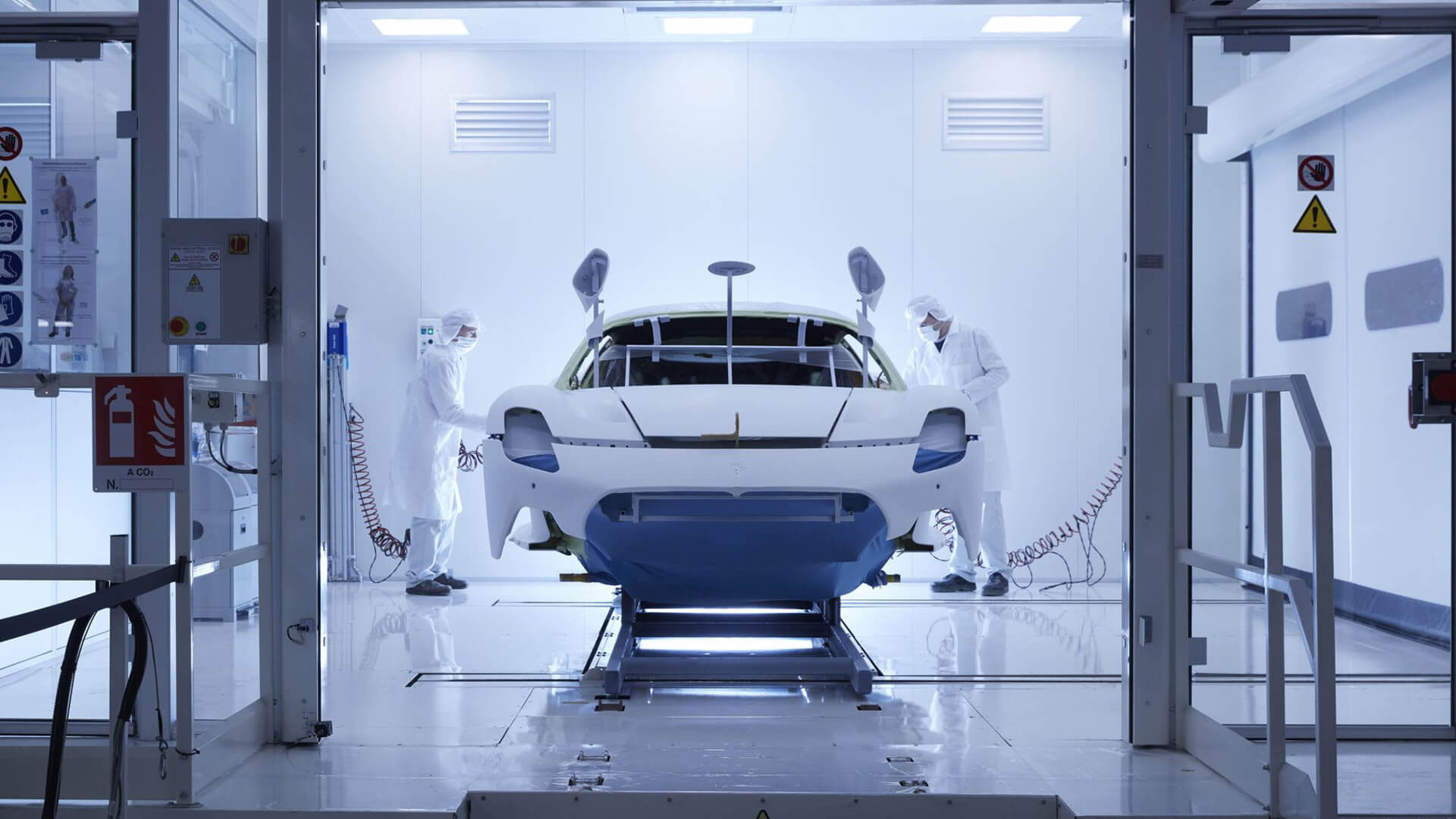 Maserati bodywork being painted by skilled workers in an aerospace-like environment