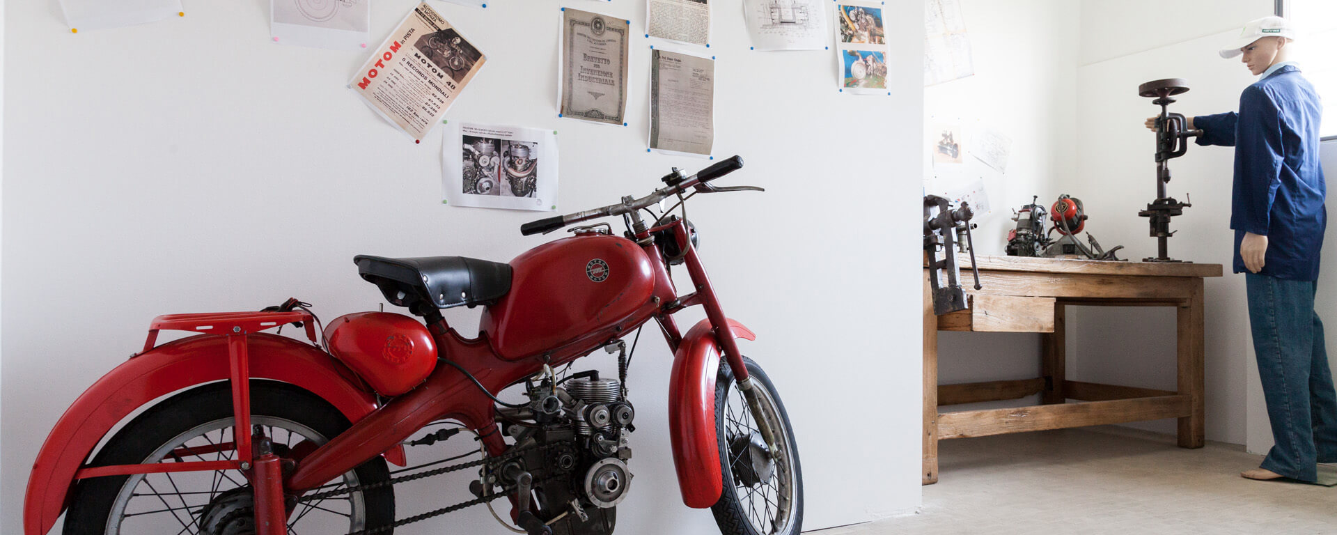 An old red model of motomotorcycles, inside the motorcycle museum in scortichino