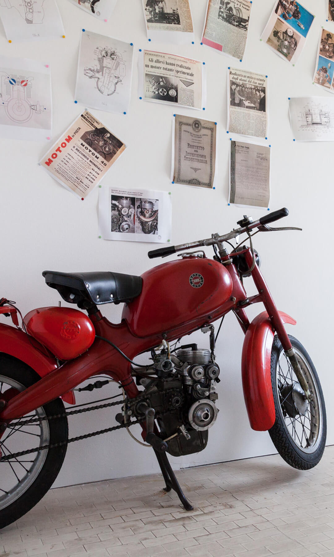 An old red model of motomotorcycles, inside the motorcycle museum in scortichino