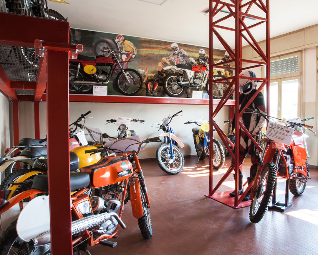 Inside the scortichino motorcycle museum, a room dedicated to dirt bikes displays several collectible motocross and enduro models.