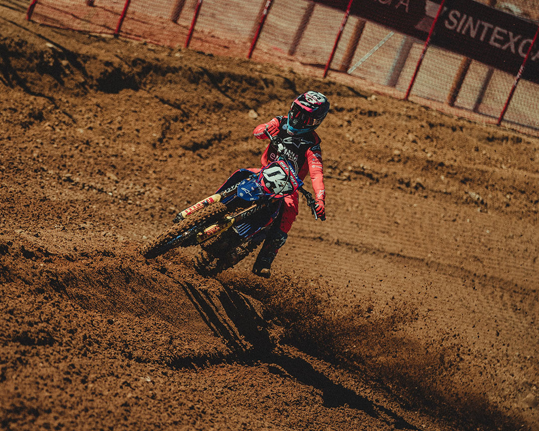 motocross rider steering on track soil