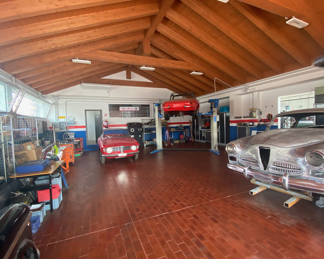 Garage interior with various models of classic cars waiting to be restored