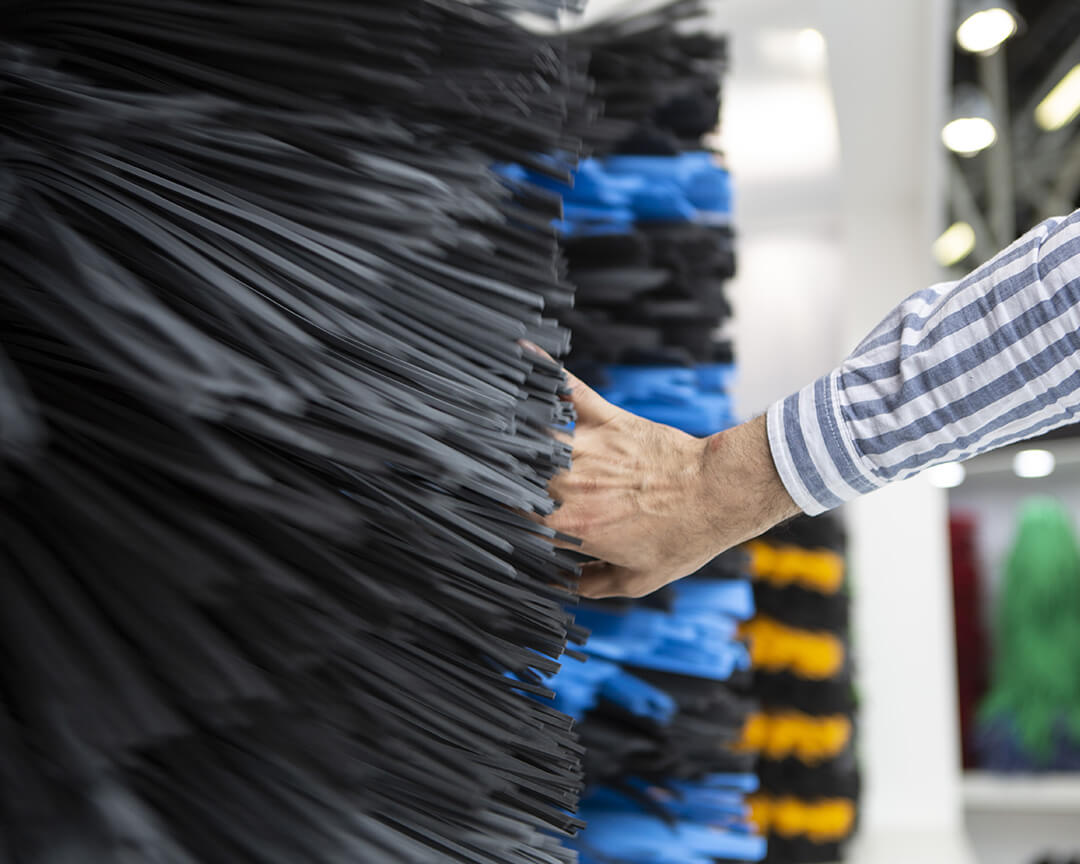 Hand touching different rubber tyre fibres