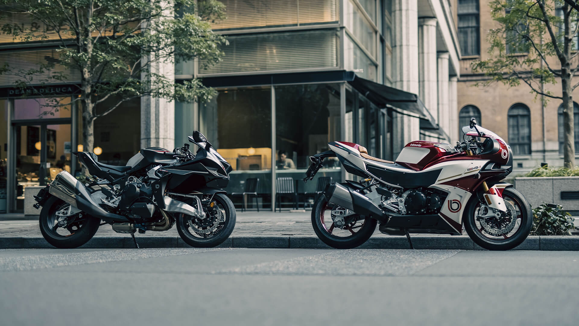 Two Bimota motorbikes parked outside a bar in town