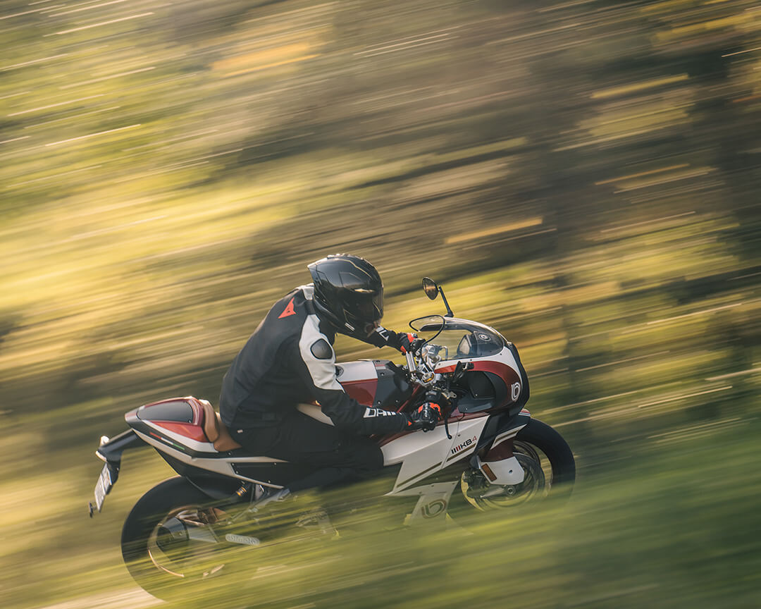 Biker and Bimota motorbike model KB4 speeding through the woods