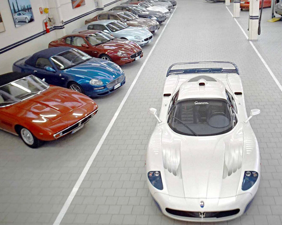 pearl-white Maserati sports car parked in the Campana body shop
