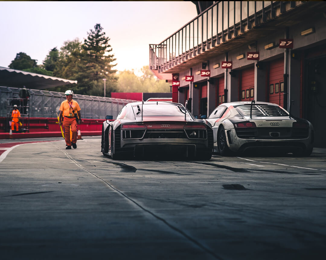 Two Audi brand race cars on circuit stopped waiting to start again