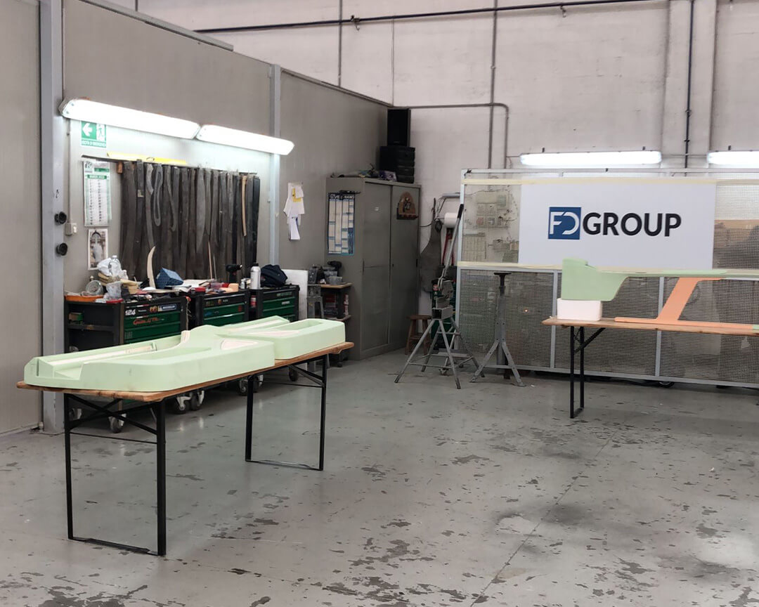 interior of an FD Group workshop where workpieces can be seen above tables, and on the left a work table