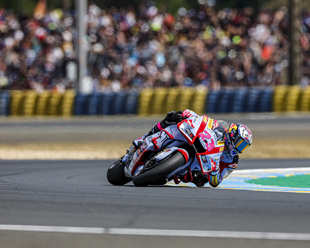 Gresini Racing rider Enea Bastianini taking a turn while running a MotoGP grand prix on his number 23 bike.