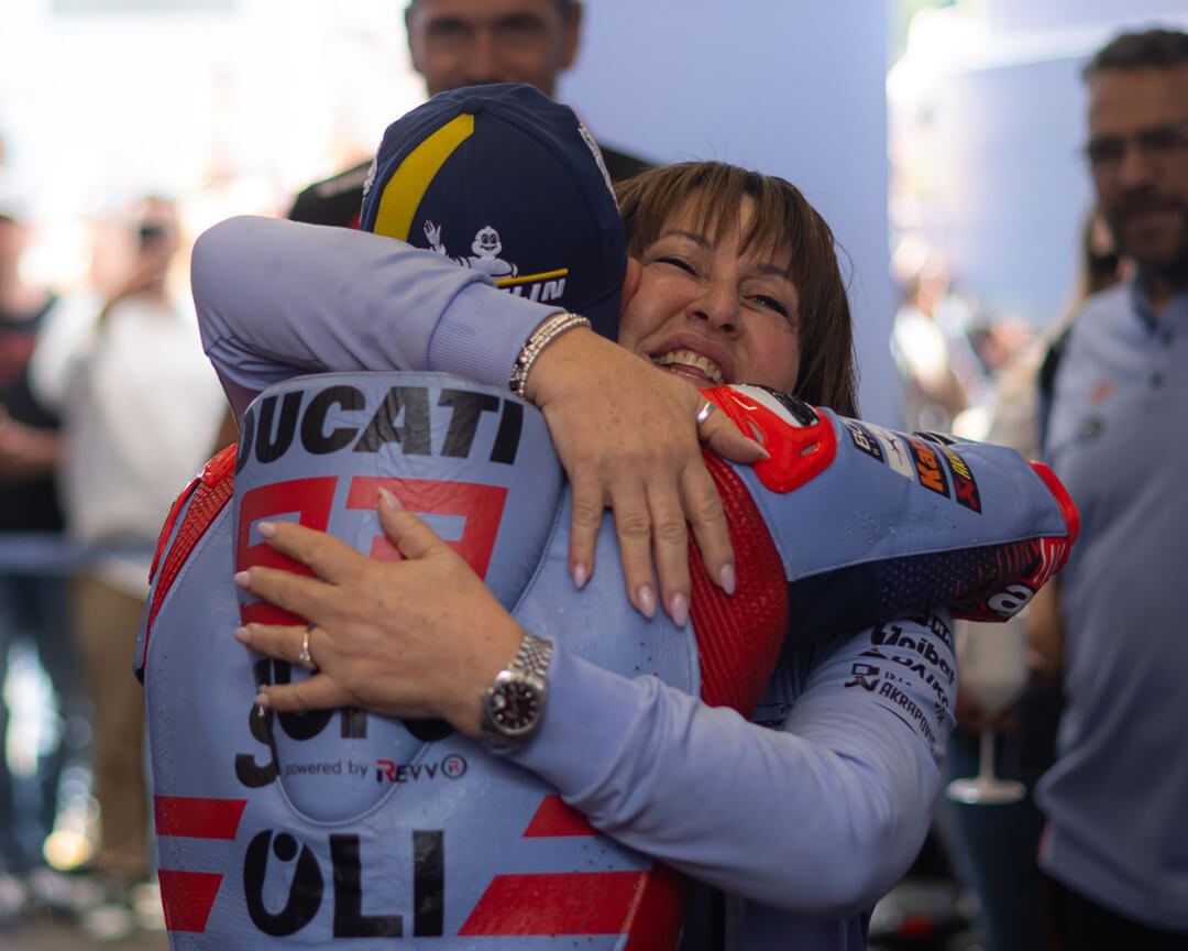 Nadia Padovani, leader of the Gresini Racing team, hugging one of the official riders during a MotoGP grand prix celebration