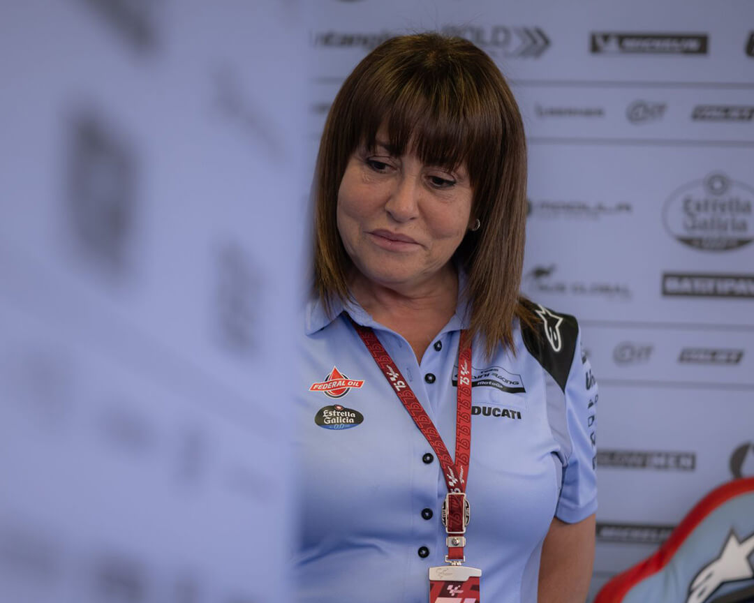 Nadia Padovani, leader of the Gresini Racing team, observing her team inside the Gresini racing pit.