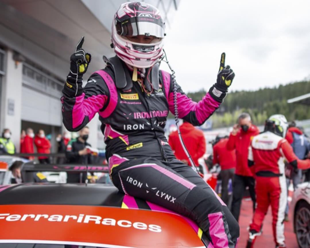 Iron Dames driver on the roof of his Ferrari celebrating with fingers raised to the sky