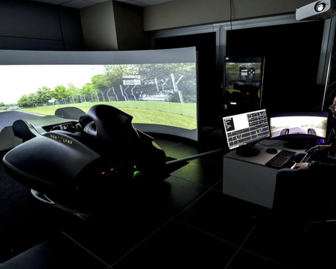 Advanced Iron Lynx driving simulator, statistics of which are analyzed and tracked by a technician.