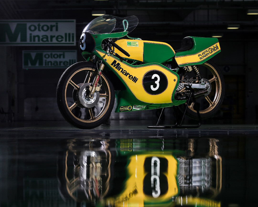 Minarelli racing motorcycle with yellow and green livery, with the number three on reflective floor