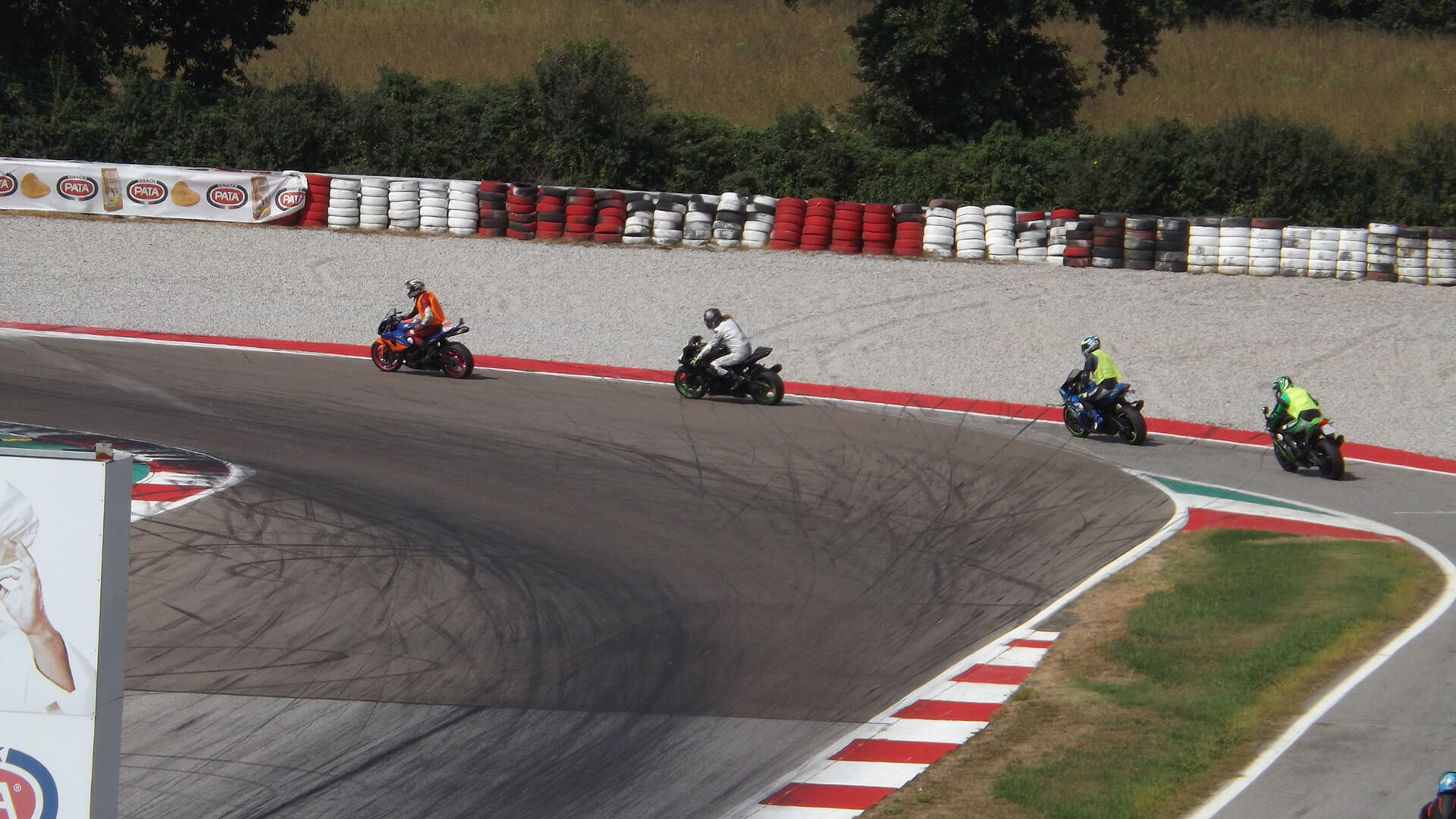 Circuit with 4 racing bikes with riders and tire marks