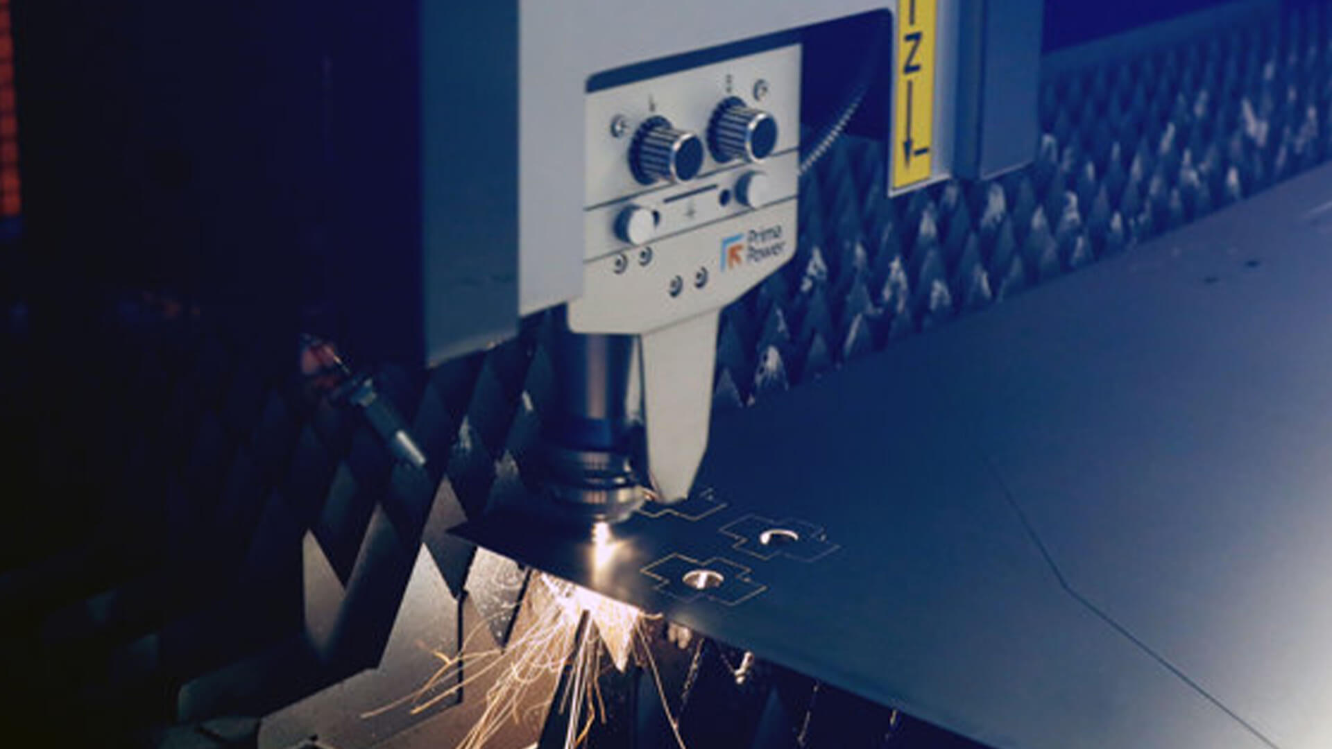A laser machine carves components on a metal plate for the construction of a vaccari e bosi frame