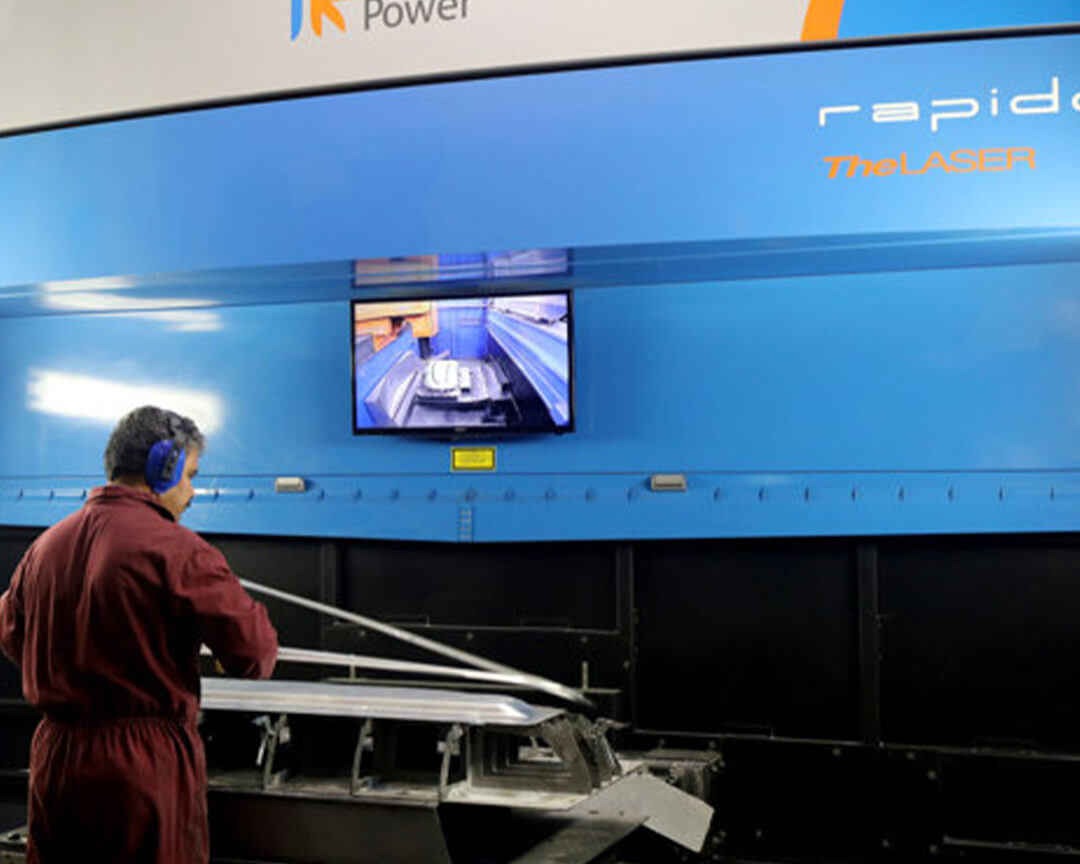 A vaccari e bosi technician, using a machine and cameras works on a car chassis