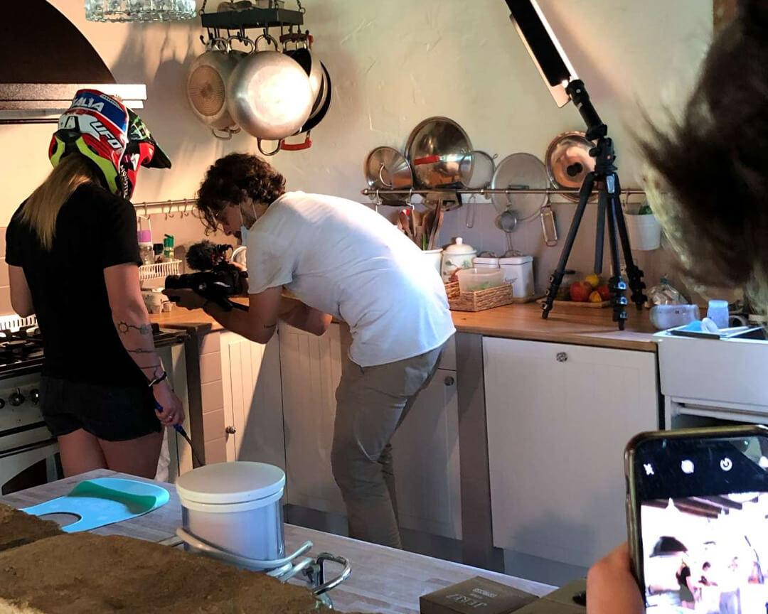 Kiara fontanesi with a motorcycle helmet on her head in her kitchen during a photo shoot
