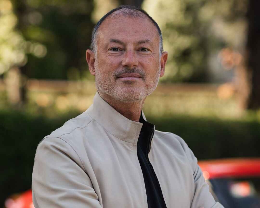 Luigi Orlandini posing for a photo with blurred background