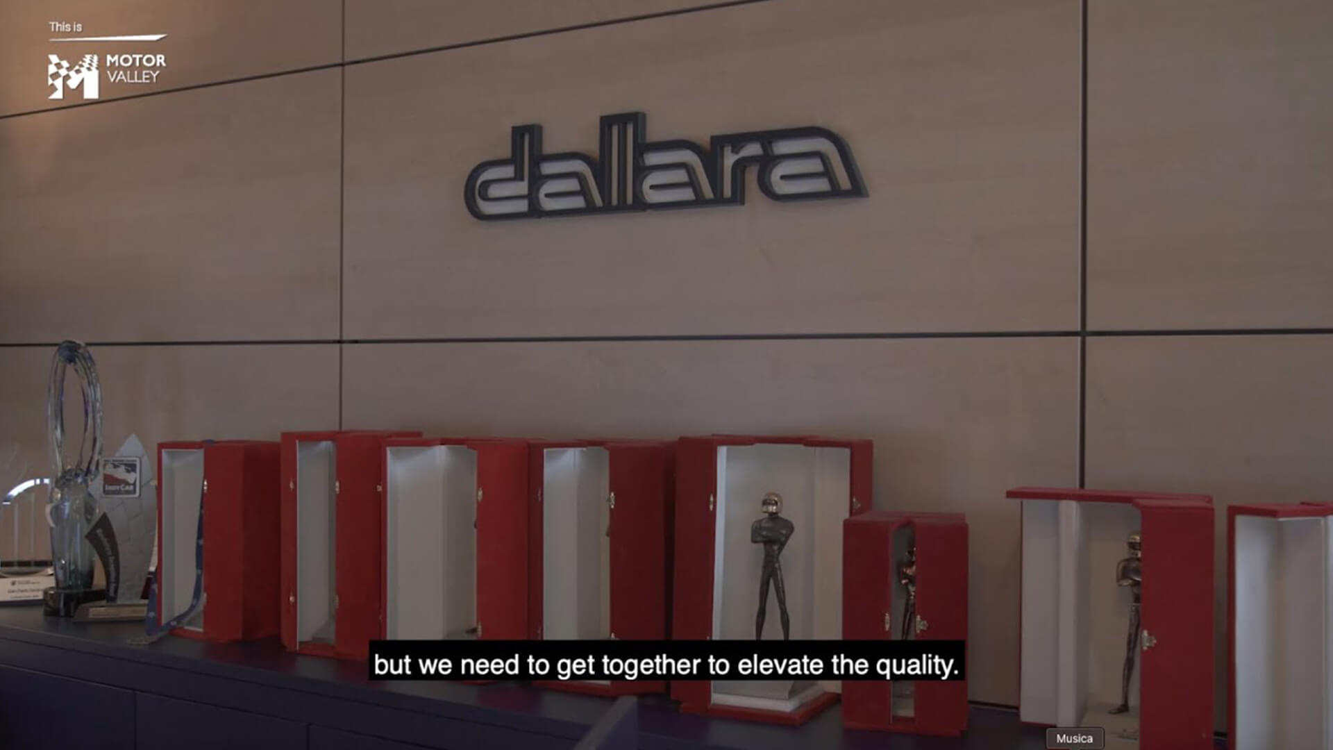 Press in red packages lying on shelf and above on the wall the Dallara sign