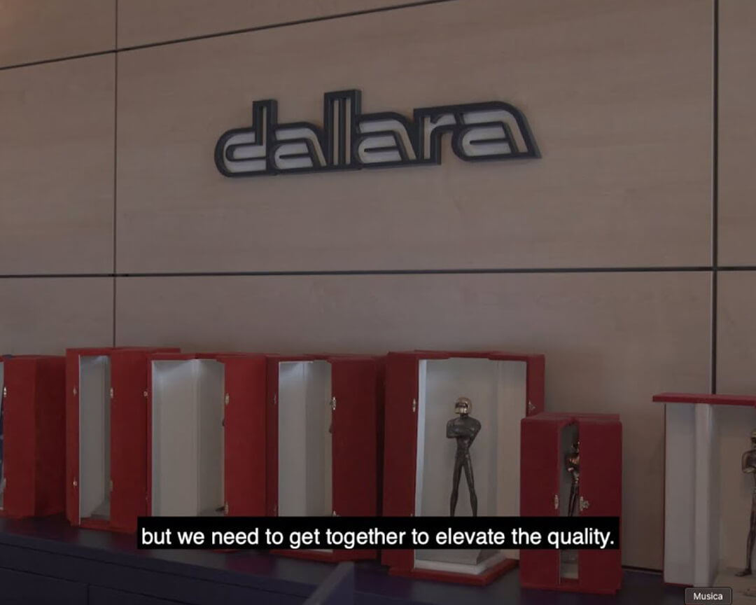 Press in red packages lying on shelf and above on the wall the Dallara sign