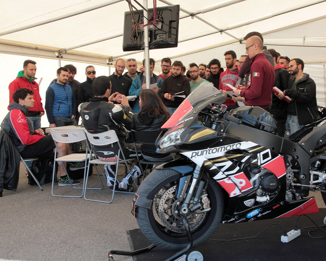 Riders and students compare after a practical session in the master’s degree of engineering of racing bike