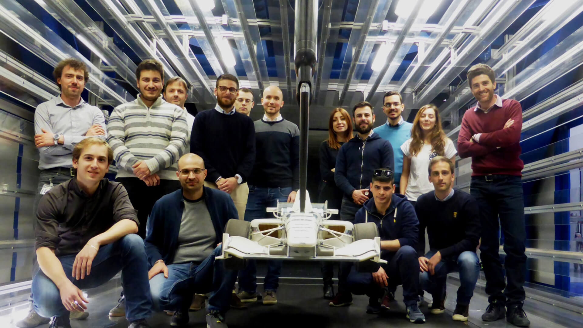 group photos of students and teachers around a model racing car