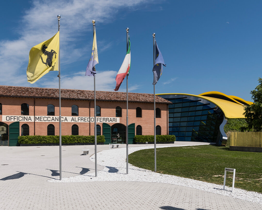 photo of Officina Storica Ferrari with flags in front