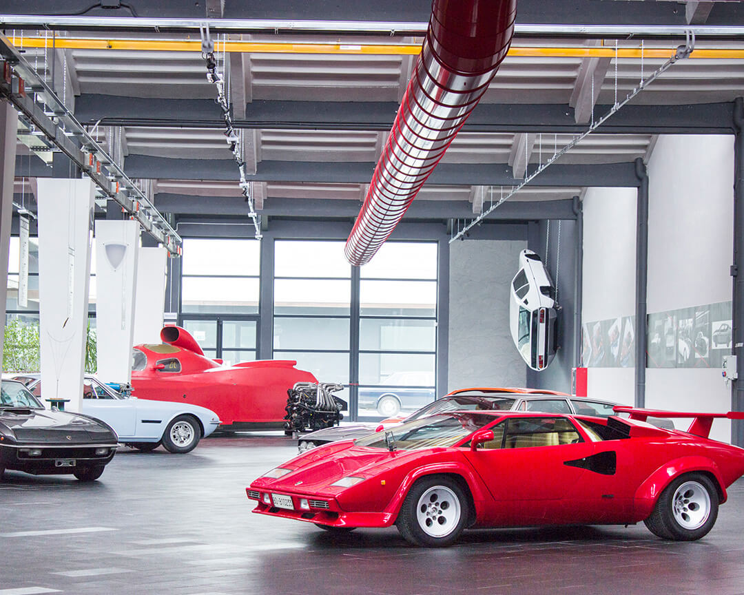 view of the main hall of the ferruccio lamborghini museum with a red countach and other cars on display