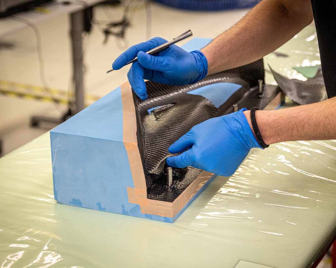 operator works a technical fabric on a mold that will then be a component of a Beltrami bike