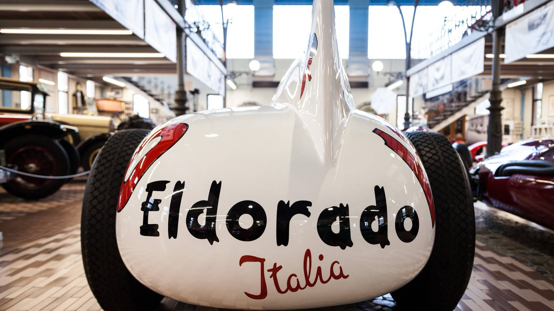 Eldorado Italia lettering on back of white Maserati eldorado single-seater car