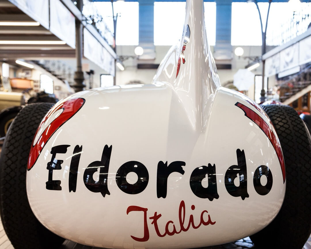 Eldorado Italia lettering on back of white Maserati eldorado single-seater car